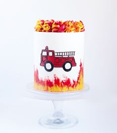 a red firetruck cake with yellow flowers on top