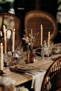 the table is set with candles and plates