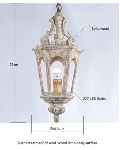 an old light hanging from the ceiling with measurements to show it's size and features