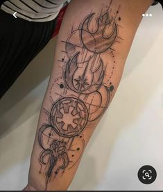 a person with a tattoo on their arm that has circles and star wars symbols all over it