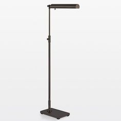 a black floor lamp on a white background with the light turned off and dimmed