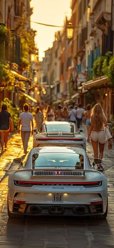 several cars parked on the street with people walking by