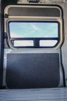 the inside of a van with its door open and windows opened to let in light