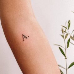 a small letter tattoo on the arm