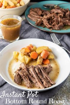 a white plate topped with meat, potatoes and carrots next to a bowl of gravy