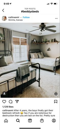 a bed room with two beds and a ceiling fan