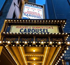 the marquee for roger's hammersie is lit up at night