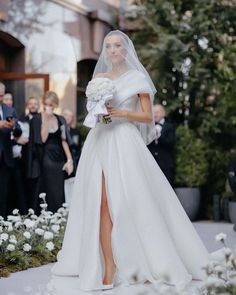 the bride is walking down the aisle in her wedding dress