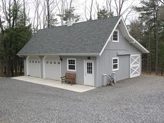 an image of a two car garage in the middle of a driveway with lots of trees