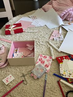 there are many crafting items on the floor with pink and white sheets behind them