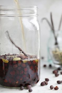 a glass jar filled with liquid sitting on top of a table