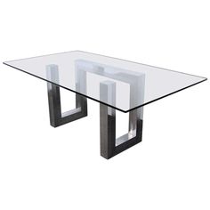 a glass table with metal legs on a white background