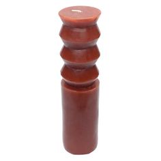 a tall brown candle holder with three candles on it's sides and a button at the top