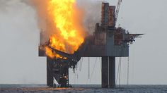 an oil rig on fire in the middle of the ocean