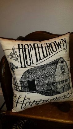 a pillow with the words home grown on it sitting on a chair in front of a wall