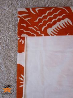 an orange and white piece of cloth on the floor