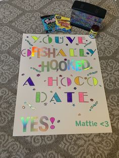 a sign that has been placed on the floor with some candy in front of it