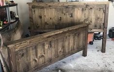 an old wooden bed frame in a room with other items on the walls and floor