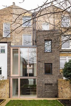 a brick building with many windows and doors