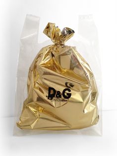 a bag that is wrapped in gold foil and has the word d & g on it