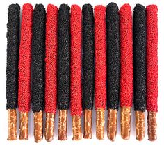 five red and black brushes are lined up in a row on a white surface,