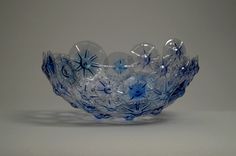 a blue glass bowl sitting on top of a table