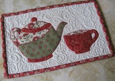 a quilted placemat with two teapots on it