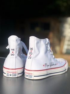 a pair of white sneakers with the words converse all star written on them are sitting on a table