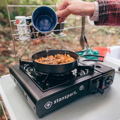 a person is cooking food on top of a stove