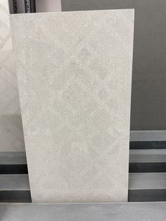 a large white marble slab sitting on top of a metal shelf