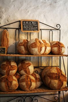 breads and rolls on display in a bakery