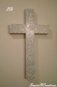 a cross made out of glitter on the wall