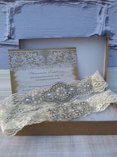 two wedding garters in a box on a table