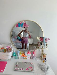 a woman is standing in front of a mirror and looking at her own personal care products