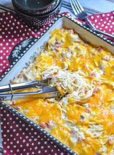 a casserole dish with cheese and meat in it on a polka dot tablecloth