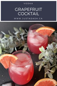 two glasses filled with grapefruit cocktail and garnished with orange slices