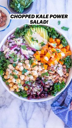 a white bowl filled with salad next to two bowls of nuts and avocado