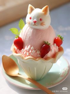 an ice cream sundae topped with strawberries and a cat figurine on top