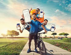 a man riding a bike while holding two cell phones in front of him and another person on the back