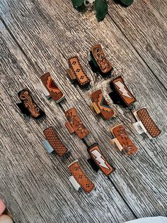 several pieces of carved wood sitting on top of a wooden table next to a plant