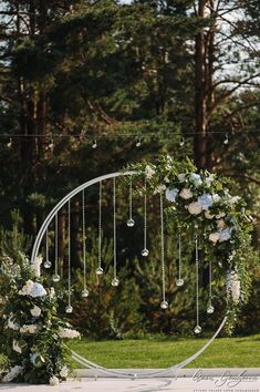 a wedding arch decorated with flowers and greenery