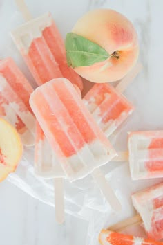 popsicles with peaches and leaves on a plate