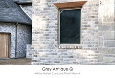 an old brick building with a window and wooden door in the middle of it that says grey antique oss