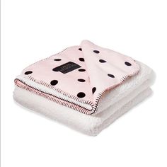 two pink and black polka dot blankets stacked on top of each other