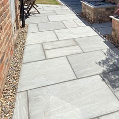 an outdoor patio with stone walkways and brick walls