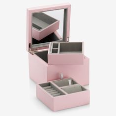 three pink jewelry boxes are stacked on top of each other, with one open and the other closed