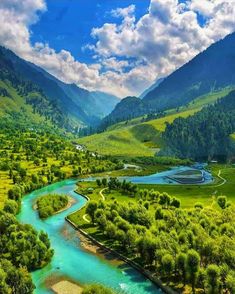 a river running through a lush green valley