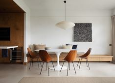 a dining room table with chairs and a bench