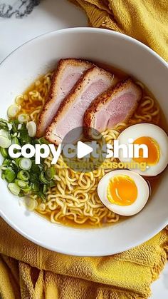 a bowl filled with noodles, meat and an egg