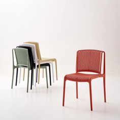 four different colored chairs sitting next to each other